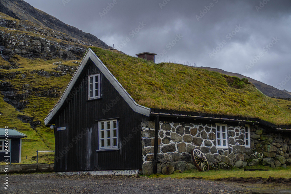 Panorama landscape scenic view of historic traditional houses with grass (turf) roof in village of Saksun, Stroymoy Island. Tourist popular attraction/destination in Faroe Islands (Denmark) 