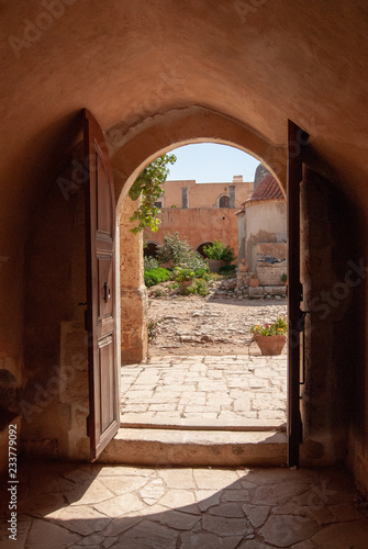 open door at sunny cortyard of monastery arkadi