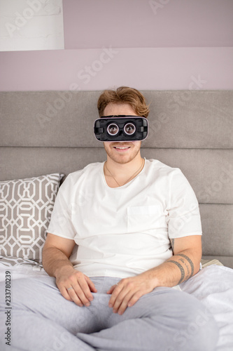 handsome man wearing virtual reality goggles at home. new world. technology, free time concept. close up photo photo