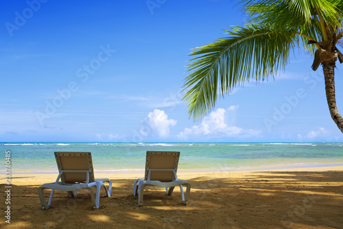 Two beach lounge on a beautiful tropical beach .