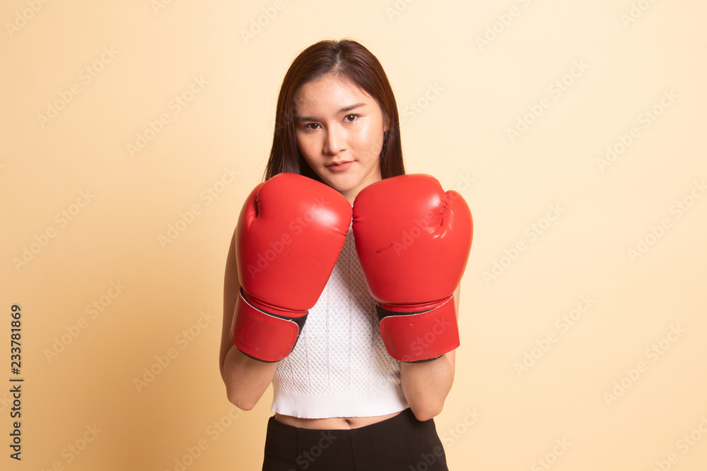 Young Asian woman with red boxing gloves. Young Asian woman with red boxing gloves.