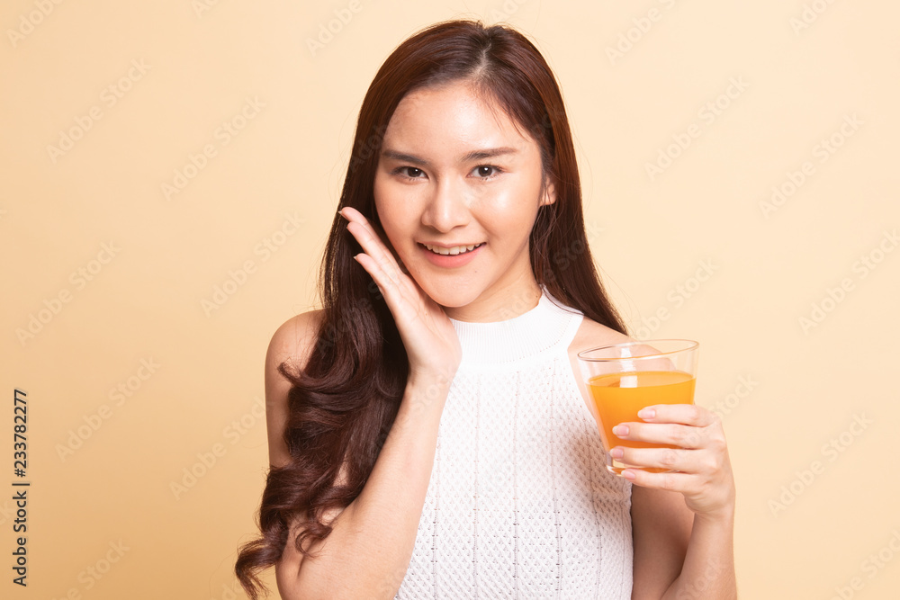 Happy Young Asian woman drink orange juice. Happy Young Asian woman drink orange juice.