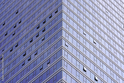 Angle modern business building skyscraper blue glass and aluminum, white square. Windows of facade. Modern apartment buildings in new neighborhood. Windows of a building, texture.