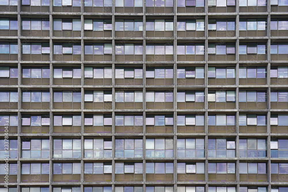 Glass grey square Windows of modern city business building skyscraper. Glass balconies in the building. Modern apartment buildings in new neighborhood. Windows of a building, texture. Glass grey square Windows of modern city business building skyscraper. Glass balconies in the building. Modern apartment buildings in new neighborhood. Windows of a building, texture.