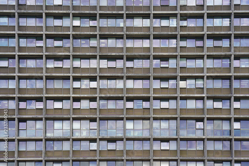 Glass grey square Windows of modern city business building skyscraper. Glass balconies in the building. Modern apartment buildings in new neighborhood. Windows of a building, texture.