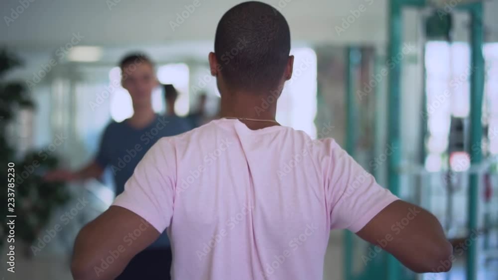 African american guy teachs young man to do exercises in the gym People in the gym Healthy lifestyle African american guy teachs young man to do exercises in the gym People in the gym Healthy lifestyle