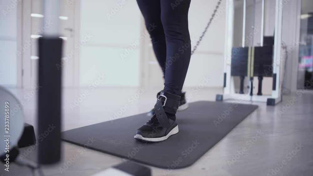 Female legs doing strength sexsercises in the gym People in the gym Female legs doing strength sexsercises in the gym People in the gym