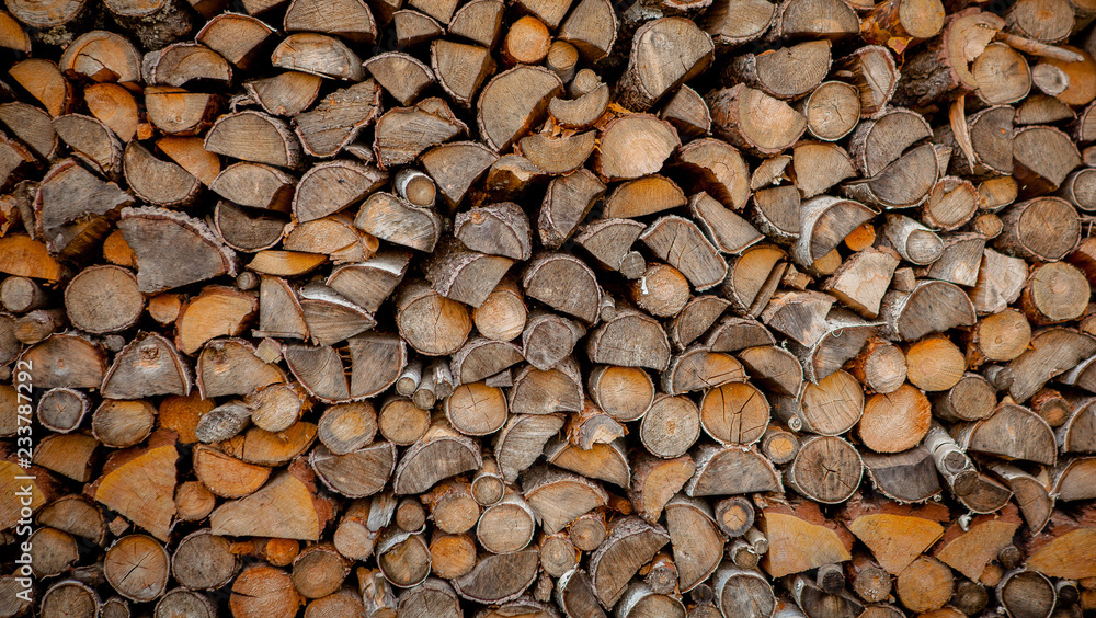 Material for heating the house. Preparation of firewood for the winter. background of firewood. A pile of firewood Material for heating the house. Preparation of firewood for the winter. background of firewood. A pile of firewood