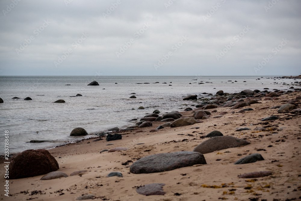 rocky coastline in Latvia with flow water in the sea and large rocks