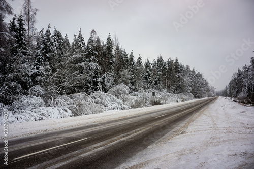 snow and ice covered road in countryside in winter
