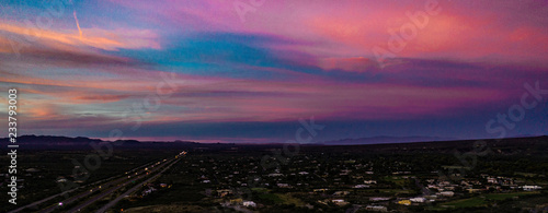 Aerial, drone view of sunset above Tubac, Arizona with mountin silhouettes and beautiful colors 