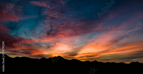Aerial, drone view of sunset above Tubac, Arizona with mountin silhouettes and beautiful colors  © joel