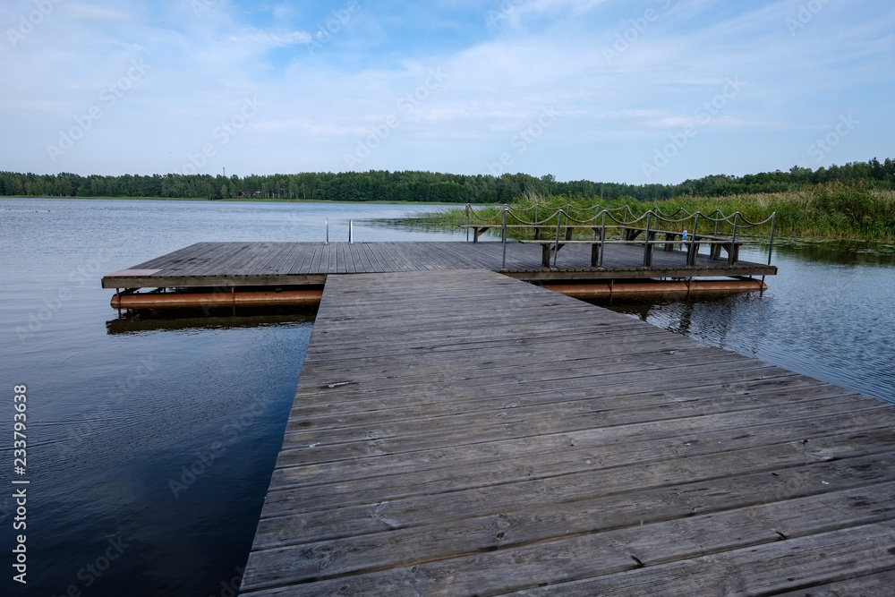 Obraz premium wooden and composite material foot bridge over water