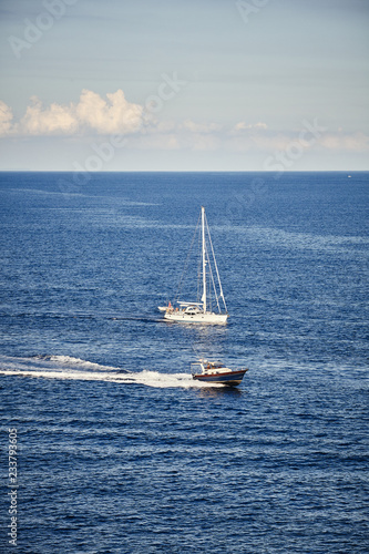 Speedboat and sailboat by the sea, travel concept. © MaciejBledowski