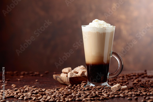 Coffee drink with cream and pieces of brown sugar.