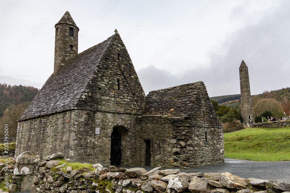 Saint Kevin's Kitchen and the Round Tower at the Glendalough Monastic Site in Wicklow, Ireland