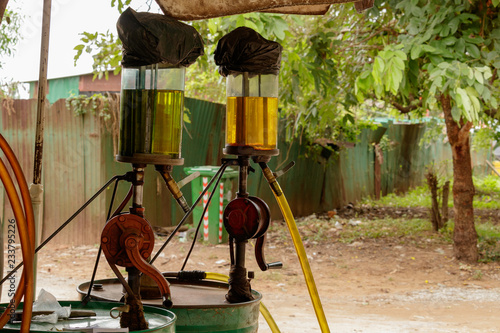 Twin hand crank fuel pumps at the side of the road in Cambodia