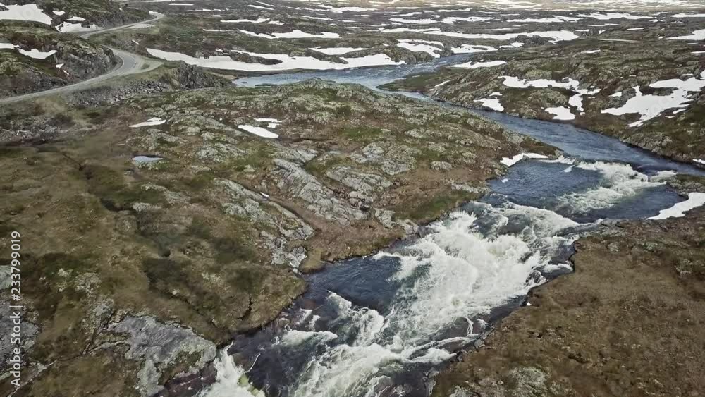 Rapid and a scenic highland road in Norway. Aerial shot. Rapid and a scenic highland road in Norway. Aerial shot.