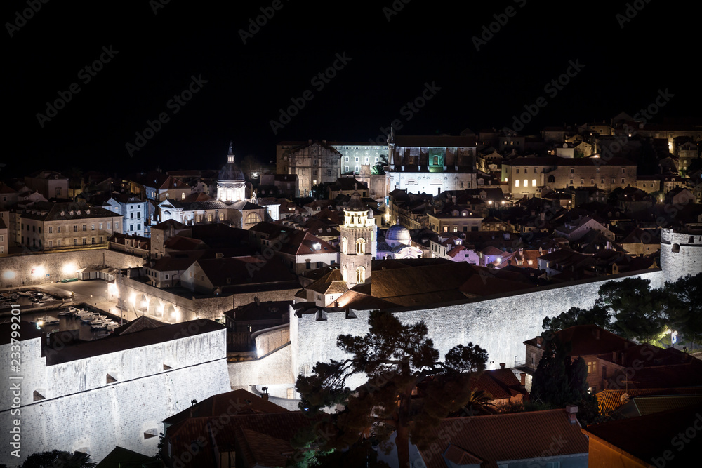 Aerial view of Dubrovnik old city at night with ligntened stone wall, Croatia