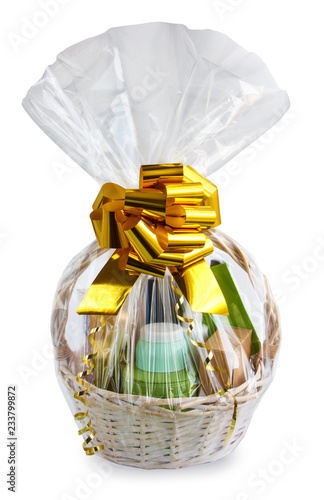 Obraz na płótnie gift basket, hamper packed in transparent paper with a big yellow bow isolated on a white background w salonie