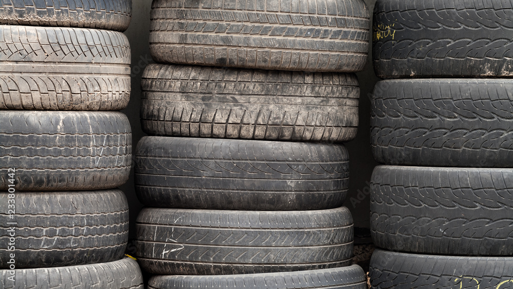 Used wheel tires stacked ready for recycling. Used wheel tires stacked ready for recycling.