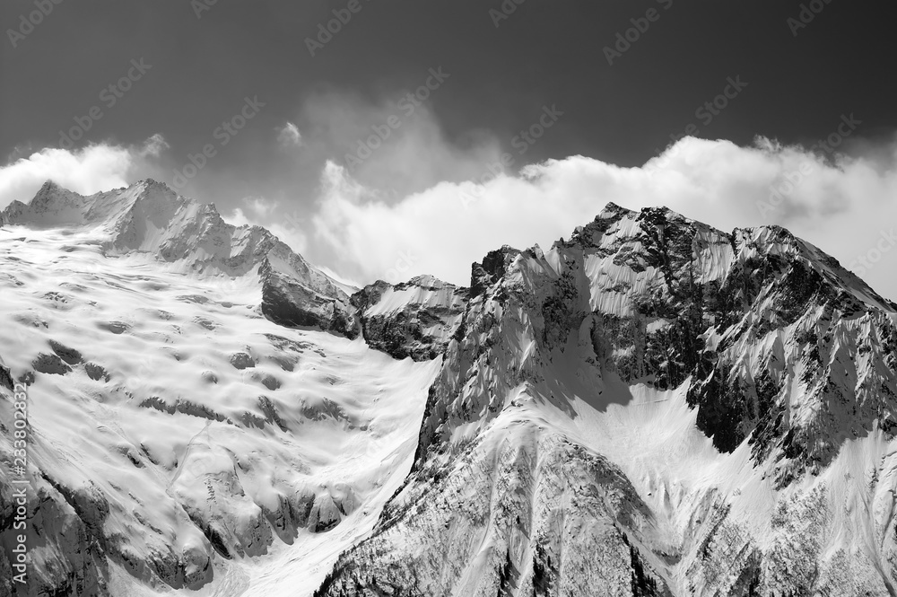Black and white view on snowy glacier and mountain peaks
