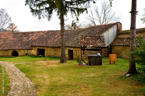 Courtyard of the medieval fortified saxon church in the village Crit-Kreutz, Transylvania, Romania photo