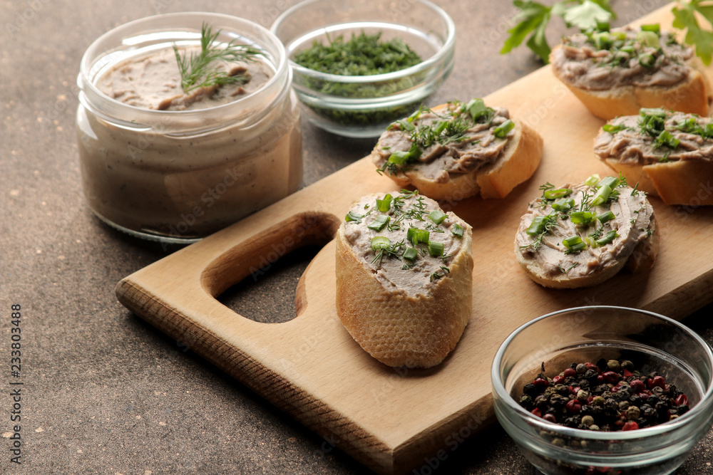 Fresh homemade chicken liver pate with greens on bread on a dark background. A sandwich. Fresh homemade chicken liver pate with greens on bread on a dark background. A sandwich.