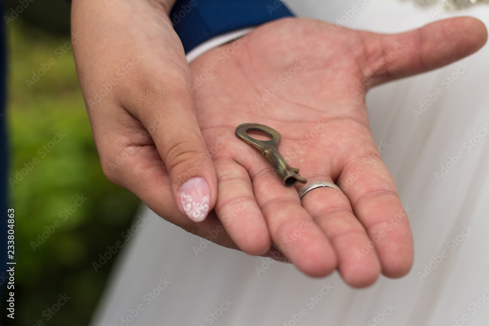 key in the hand of a man and a woman key in the hand of a man and a woman
