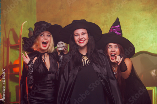 Picture of screaming three young witches in black hats