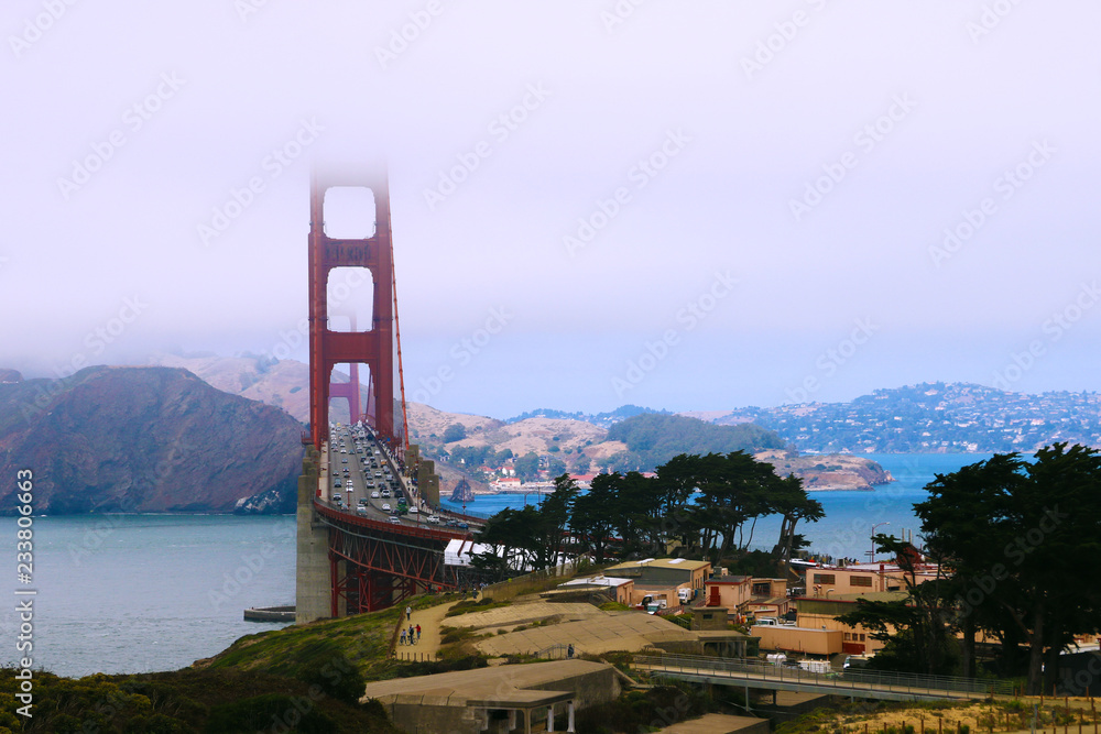 Beautiful view of the mountains and the bridge, the top of which is hidden in the fog Beautiful view of the mountains and the bridge, the top of which is hidden in the fog