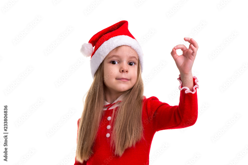 Christmas girl showing ok sign, wearing a santa costume, isolated over a white background Christmas girl showing ok sign, wearing a santa costume, isolated over a white background