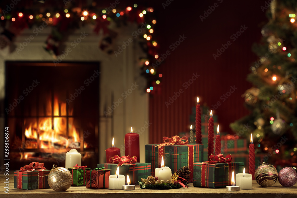 view of wrapped gifts and fireplace with christmas tree on the back