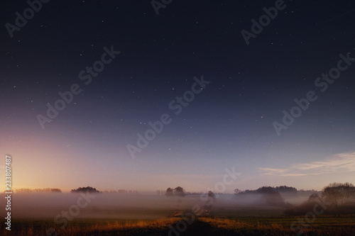 Beautiful night view nature landscape with stars and fog environment in the countryside. Braunschweig, Germany