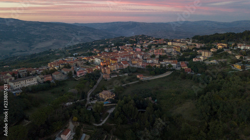 Aerial view at sunset of the small town of Montecalvo Irpino, in the province of Avellino, in Italy. This village with few houses and streets is built in the mountains of Irpinia. © Stefano Tammaro
