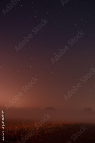 Beautiful night view nature landscape with stars and fog environment in the countryside. Braunschweig, Germany