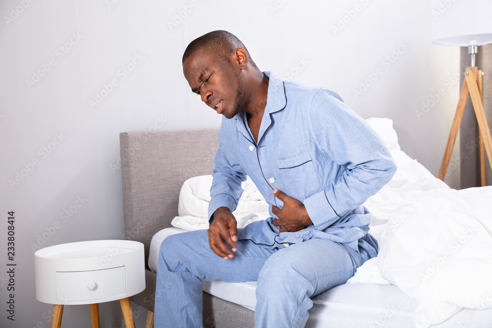 Man Suffering From Stomach Pain Man Suffering From Stomach Pain