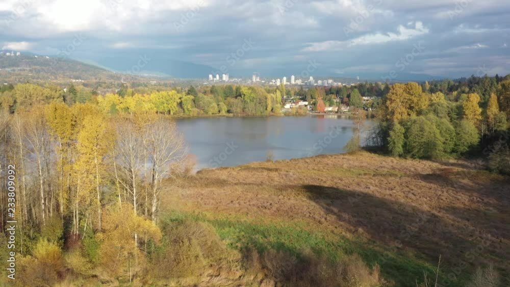 Aerial View at Mountain Lake on sunny and cloud fall afternoon in British Columbia, Canada. Mountains background. Aerial View at Mountain Lake on sunny and cloud fall afternoon in British Columbia, Canada. Mountains background.
