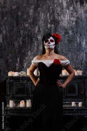 Portrait of zombie woman with white face and red flower on her head