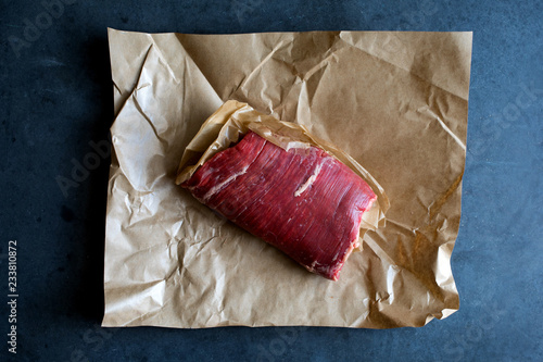 Close up of flank steak on parchment paper
