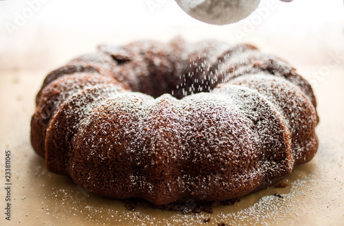 Close up of powdered sugar dusting on chocolate cake