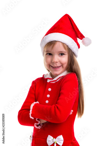 Smiling coquettish christmas girl wearing a santa hat isolated over a white background. Portrait picture