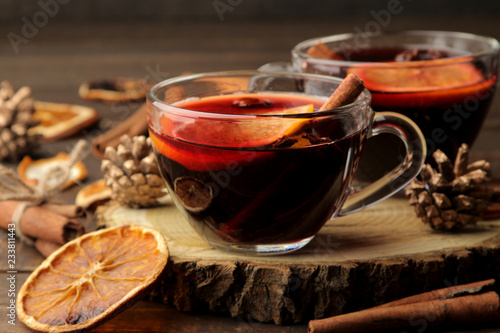 Hot mulled wine with cinnamon and orange in glass cups against a dark background. Christmas. new Year.