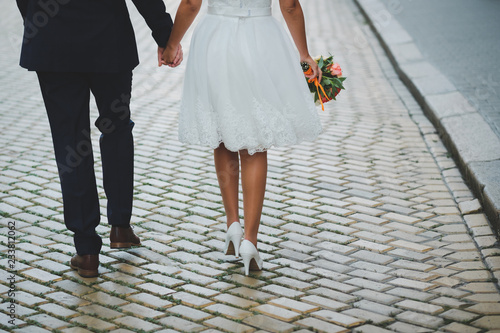 bride and groom walking on the street
