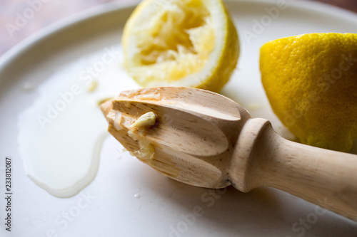 Close up of lemon with lemon reamer on plate