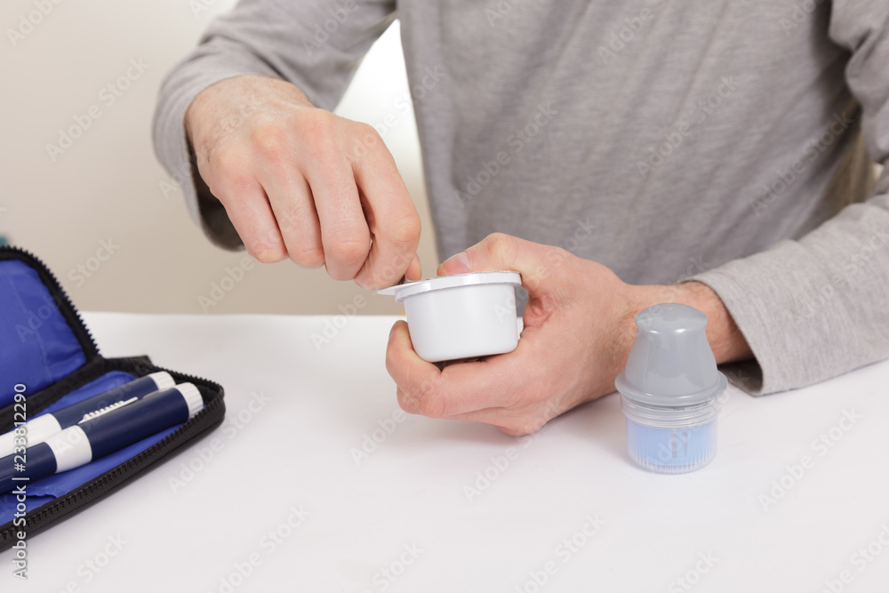 Fototapeta premium sensor diabetes checkup glucose man system sugar monitoring scan test hand skin medicine syringe table white background