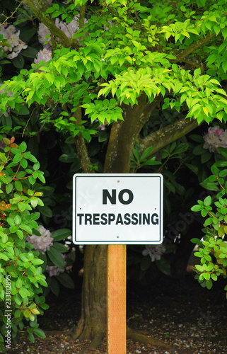 No trespassing sign posted in nature outdoors.