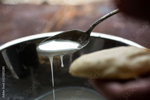 Close up of spoonful fondant icing and cookie
