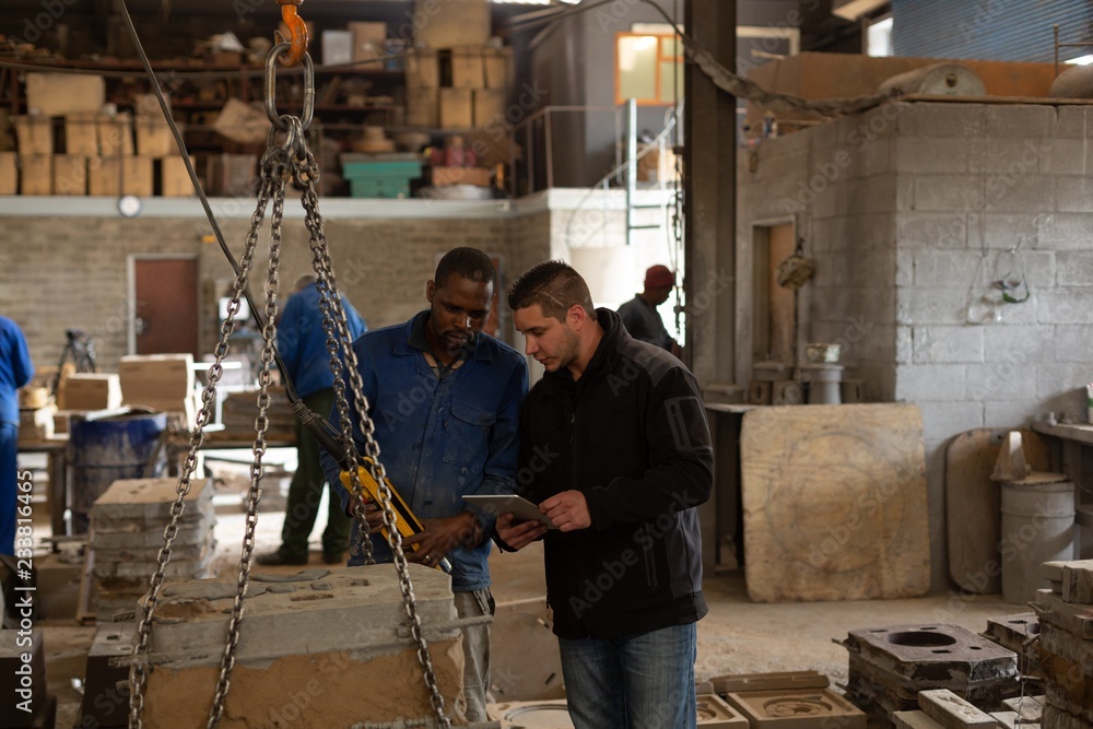 Workers discussing in foundry workshop Workers discussing in foundry workshop