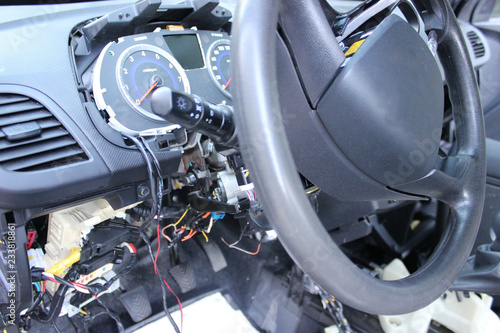 The dashboard of the car, the speedometer close-up.Repair of the car, disassembled the panel, the steering wheel.